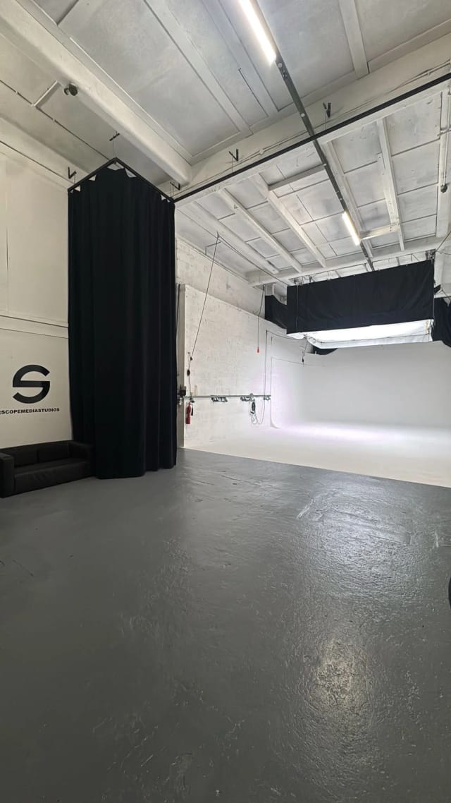 The entrance end of Studio A with the Scope Media Studios S mark painted on the white wall