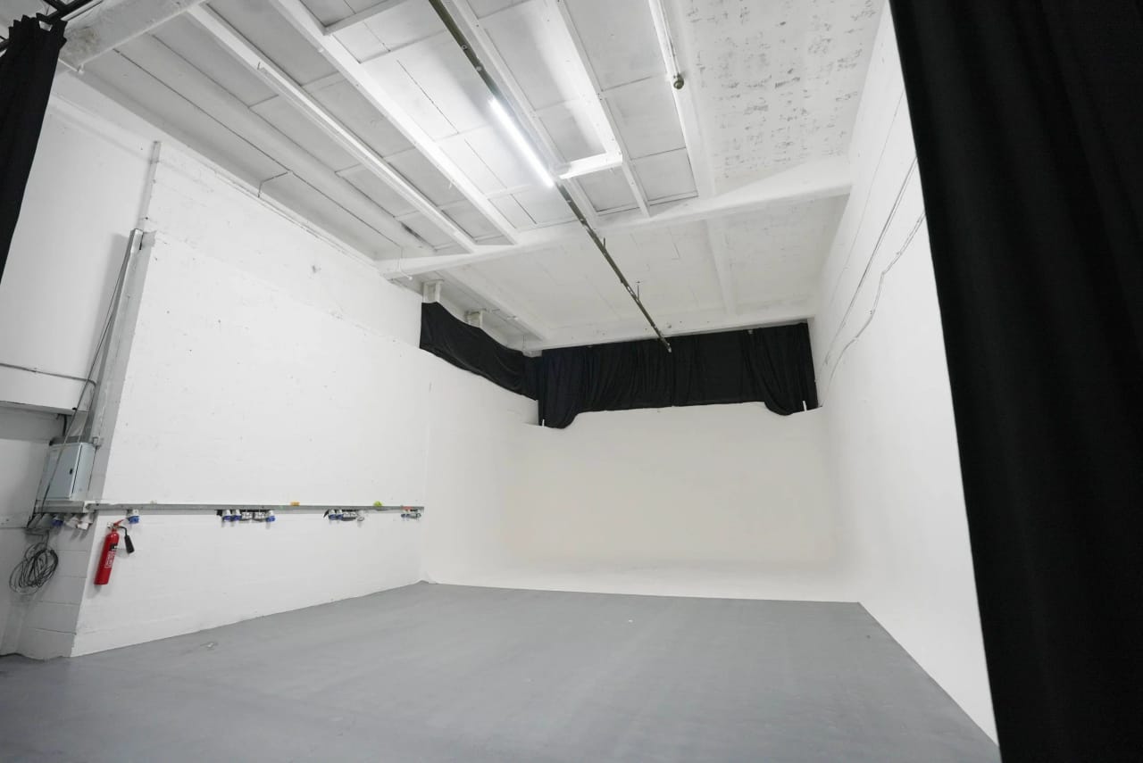 Studio A from the opposite corner showing the wall-mounted power distribution and the cove beyond
