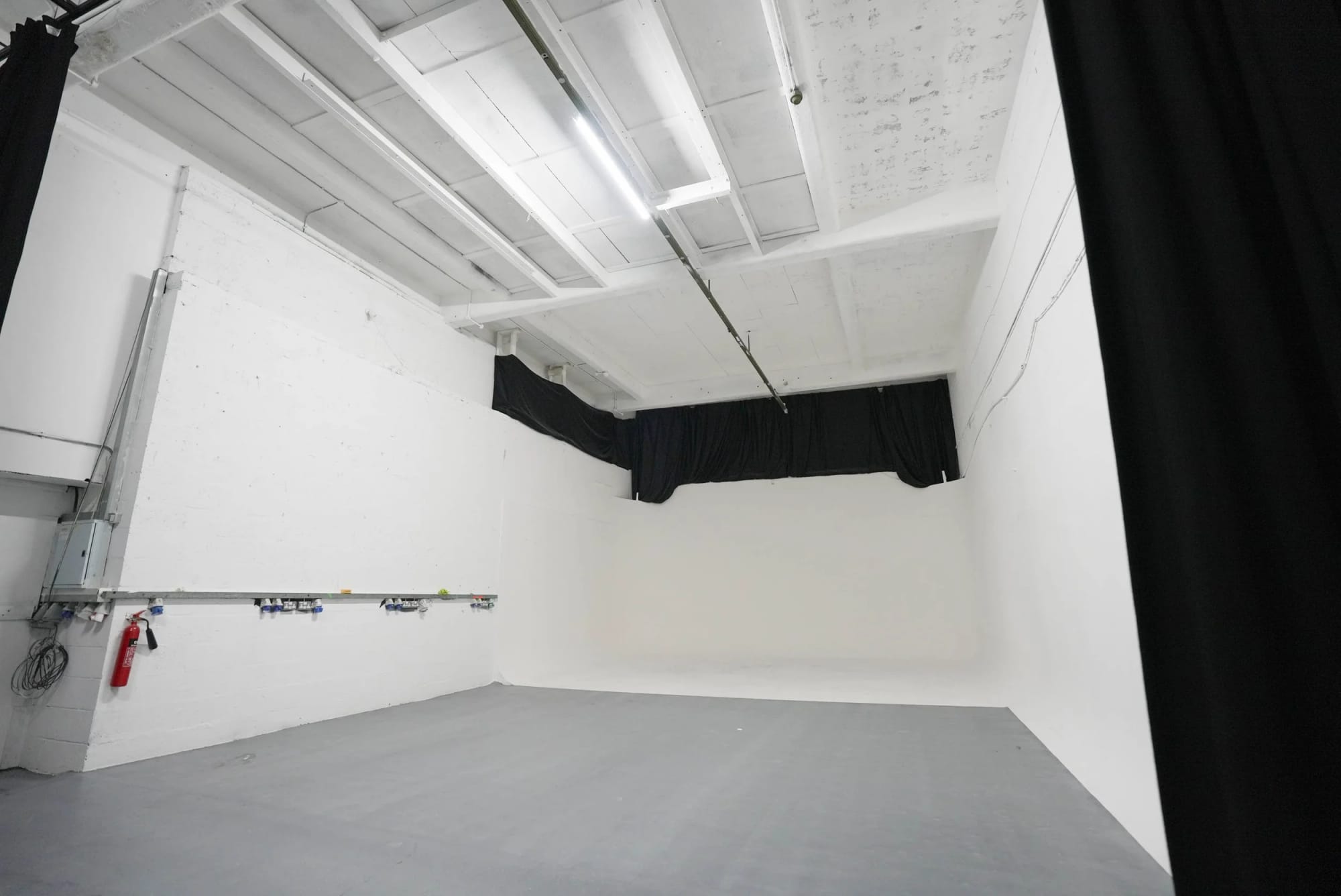 Studio A from the opposite corner showing the wall-mounted power distribution and the cove beyond