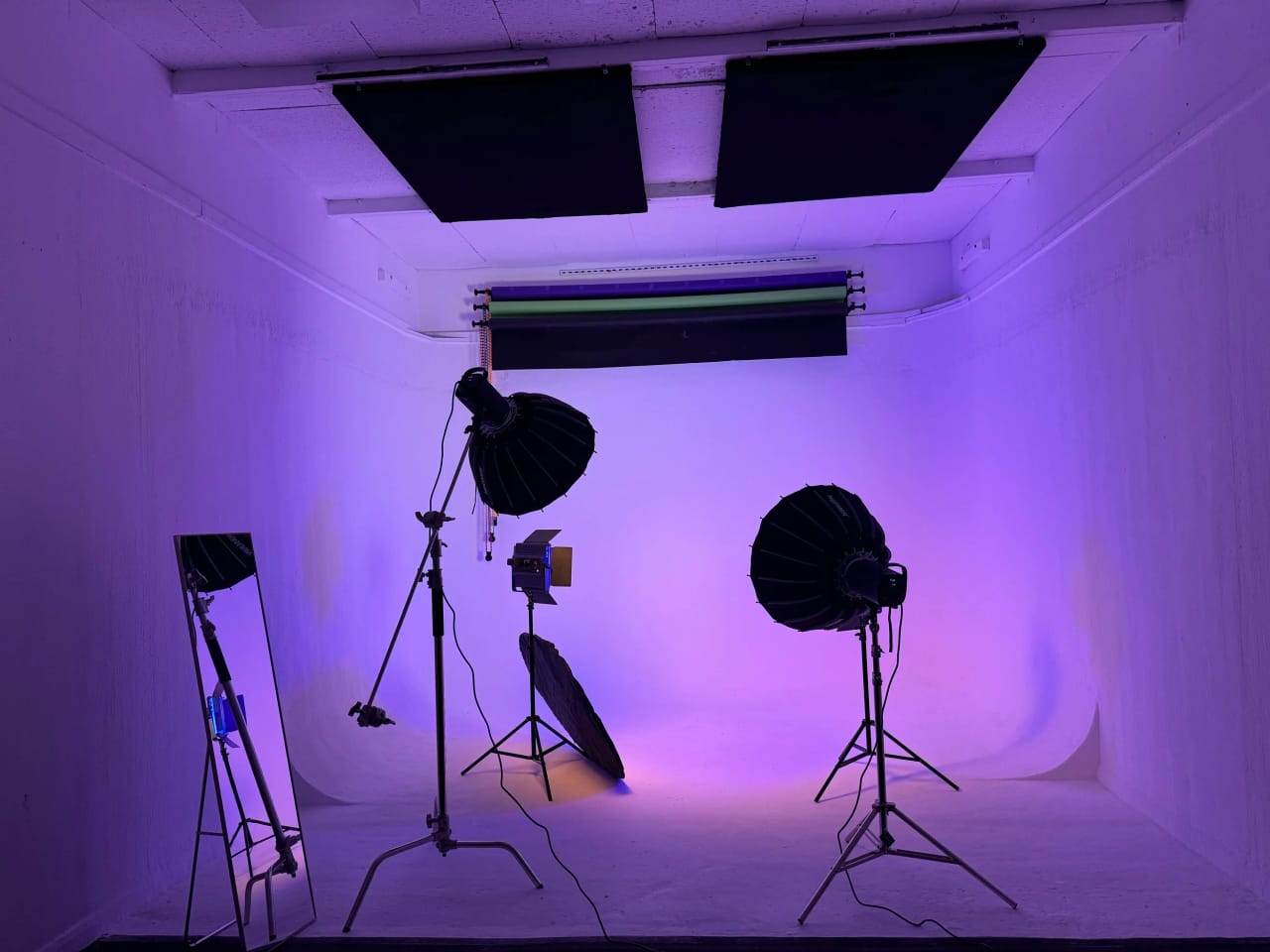 Studio B's cyclorama washed in saturated purple light with two large para softboxes and black ceiling flags
