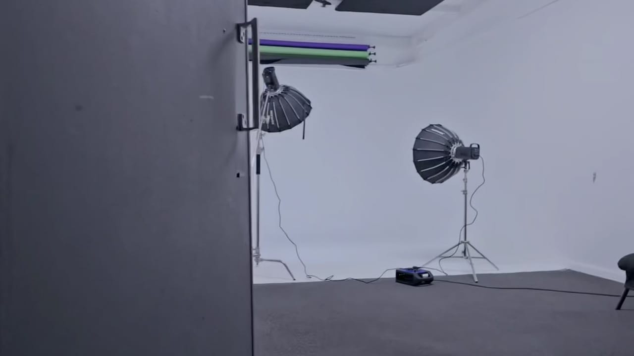 Studio B dressed with a pink sofa on the white cyclorama under a fresnel light