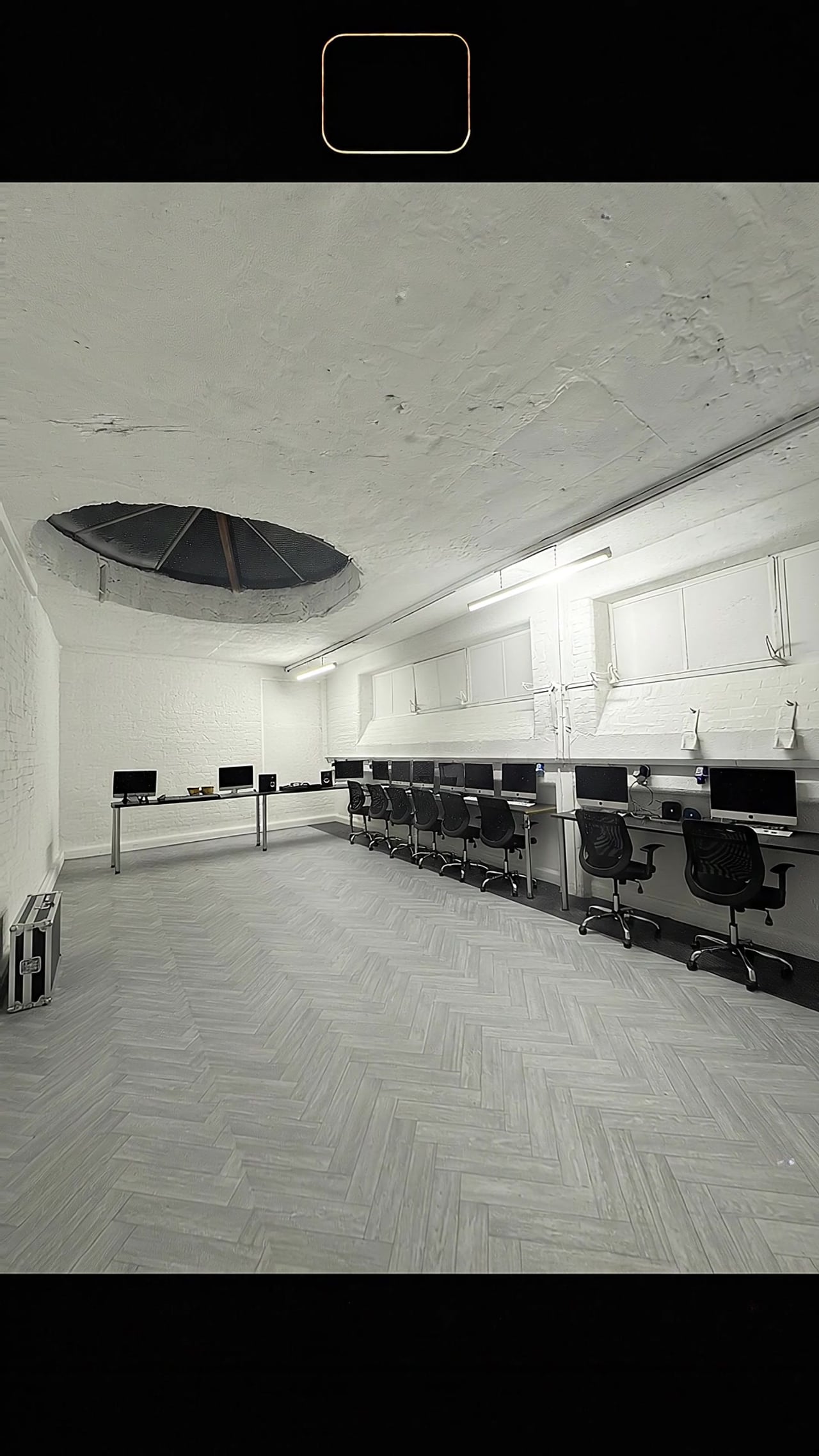 The workshop at Scope Media Studios: iMac workstations along the wall under the original circular ceiling light well.